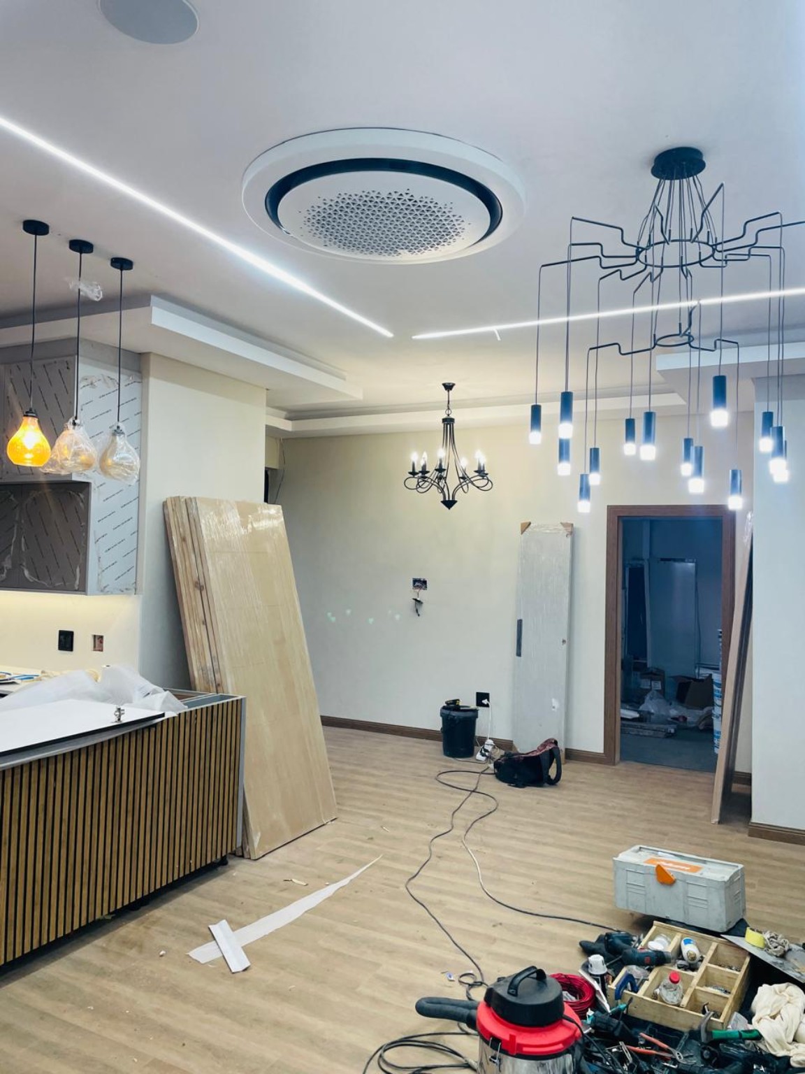 Actual interior photograph showing ceiling lighting and kitchen fit-out