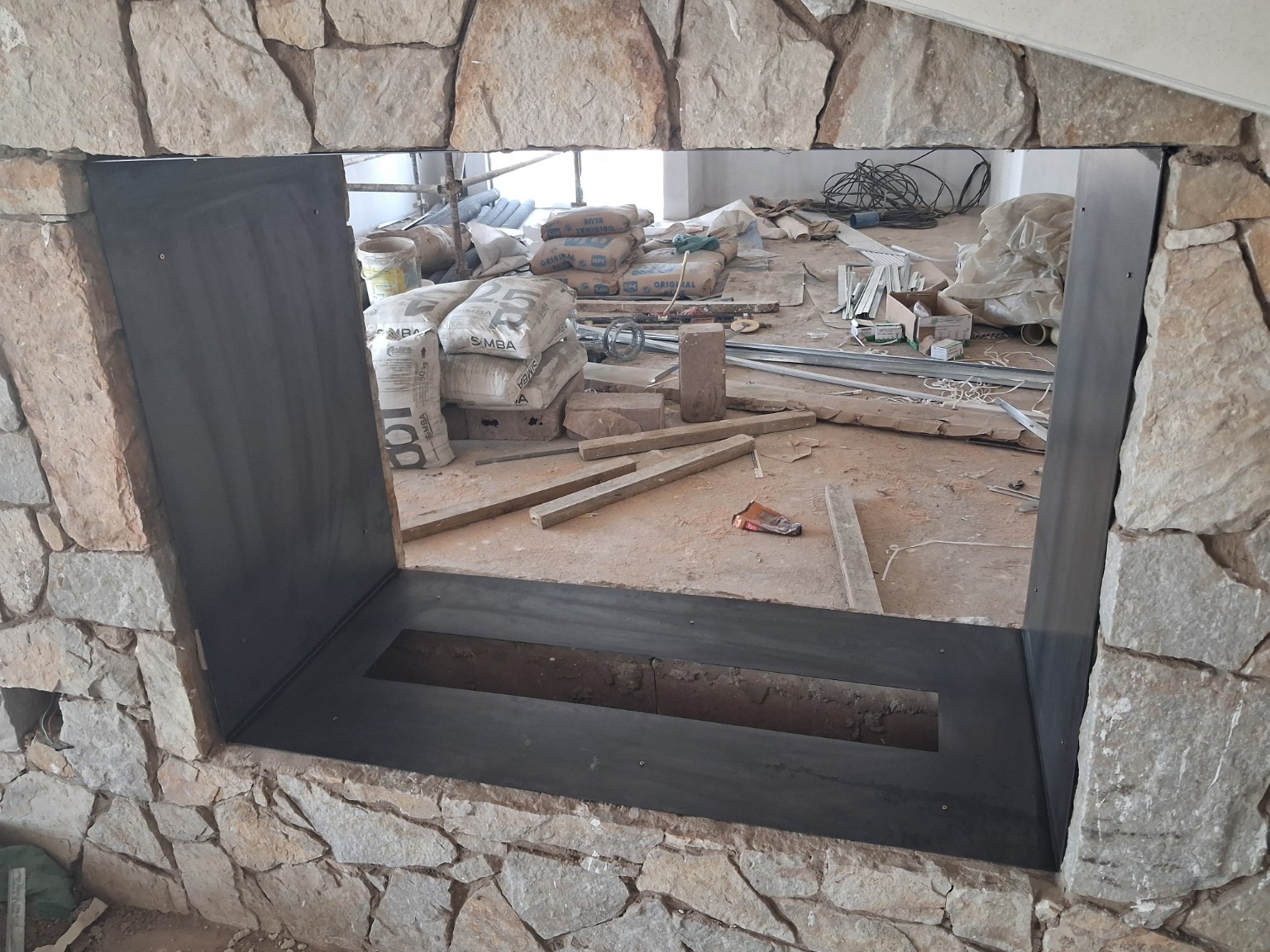 Actual project photograph showing natural-stone fireplace craftsmanship